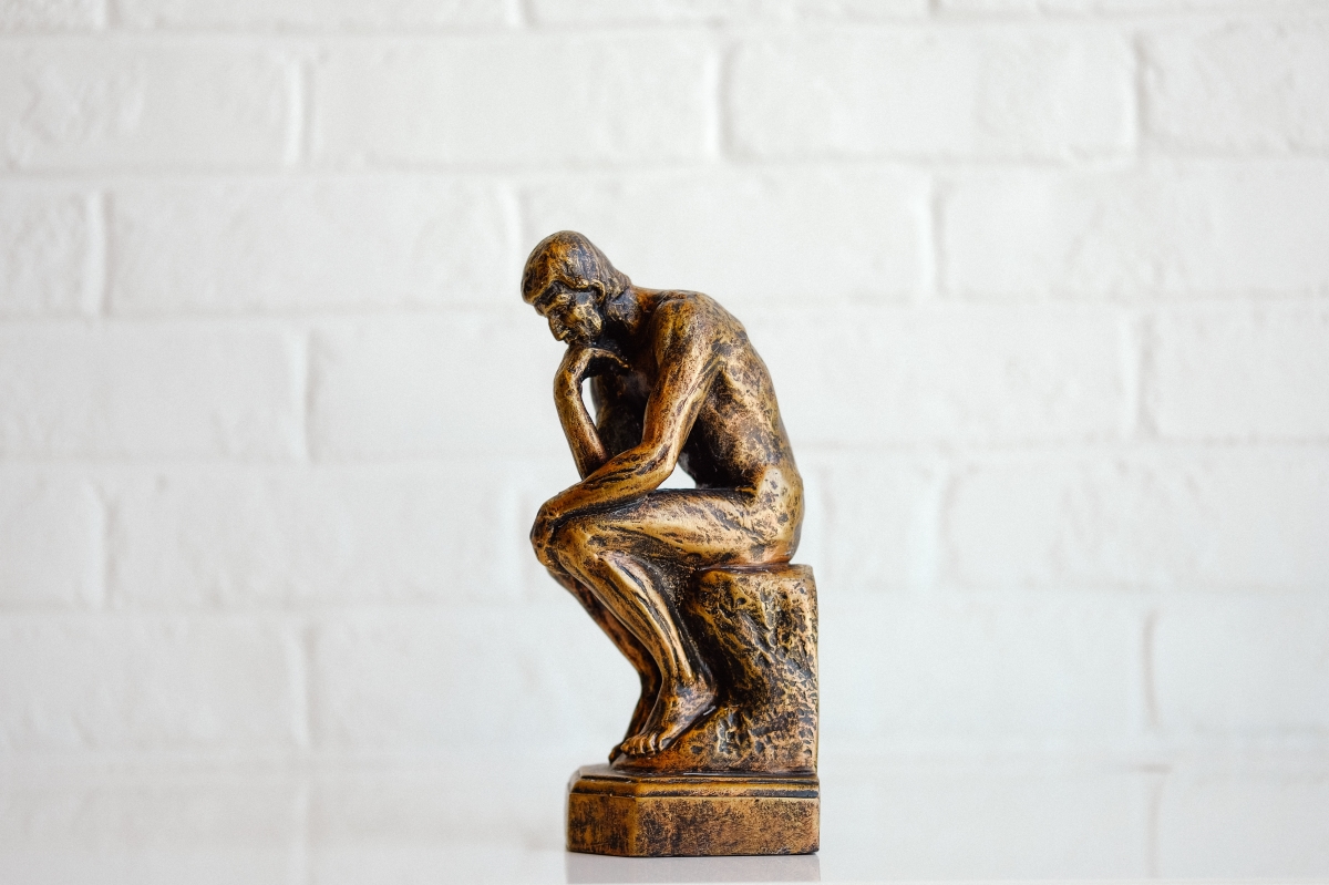 representation of shopify FAQs that is a figurine of a thinking man