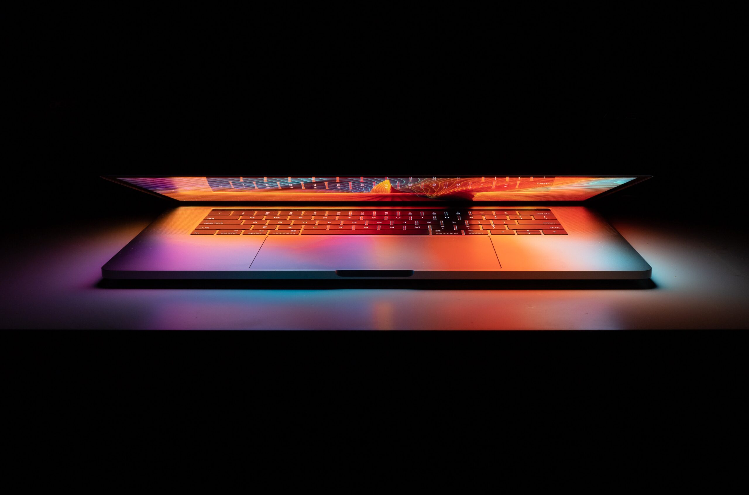 Half open laptop with colorful lights